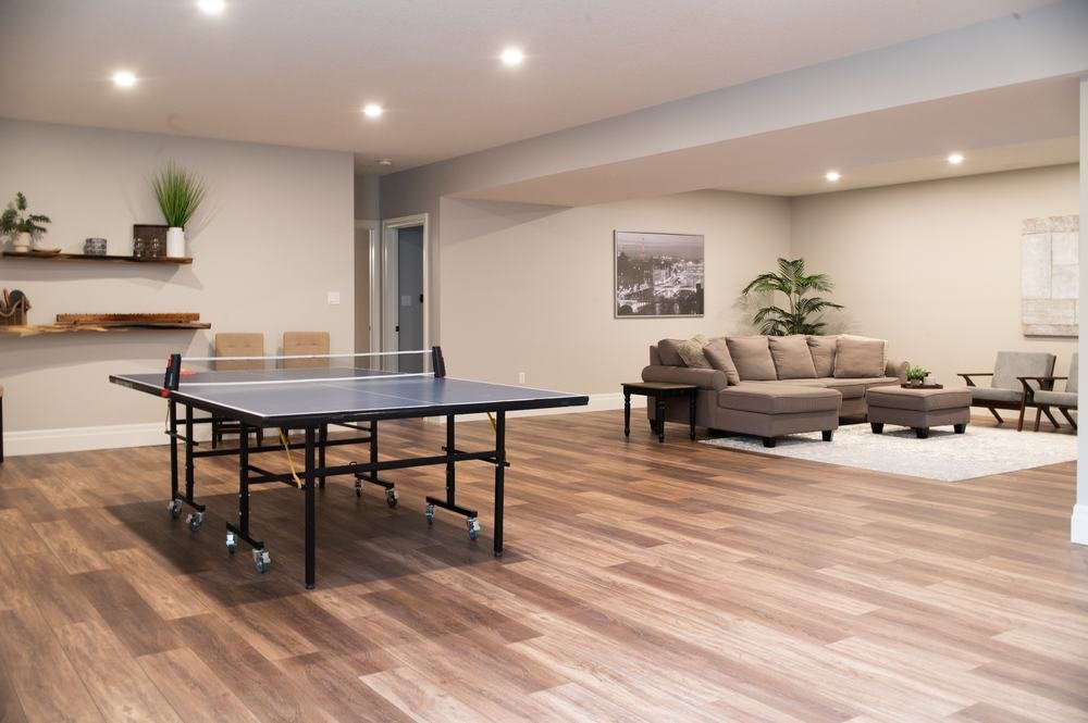 Finished basement with a stone feature wall and built-in cabinetry