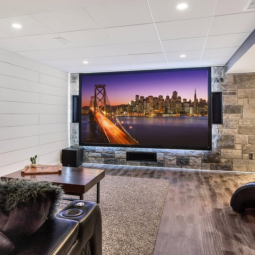 Finished media room with projection screen set into a broad stone wall