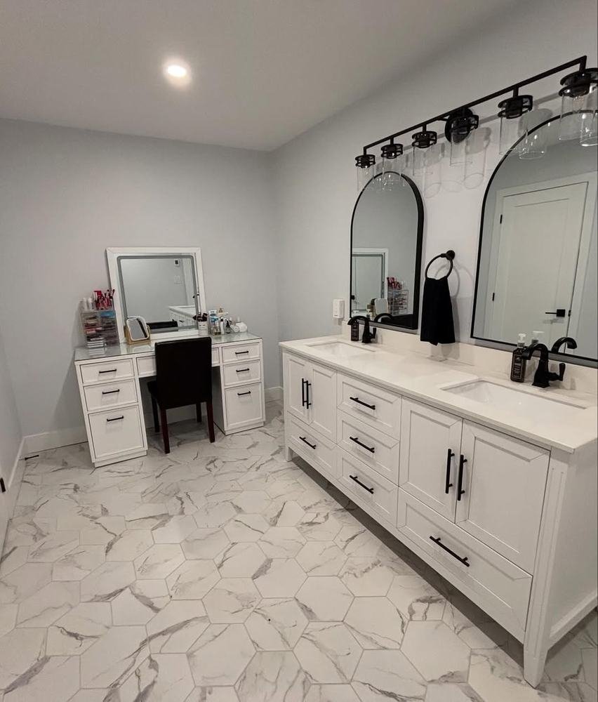 White double vanity and makeup desk on a large-format tiled floor