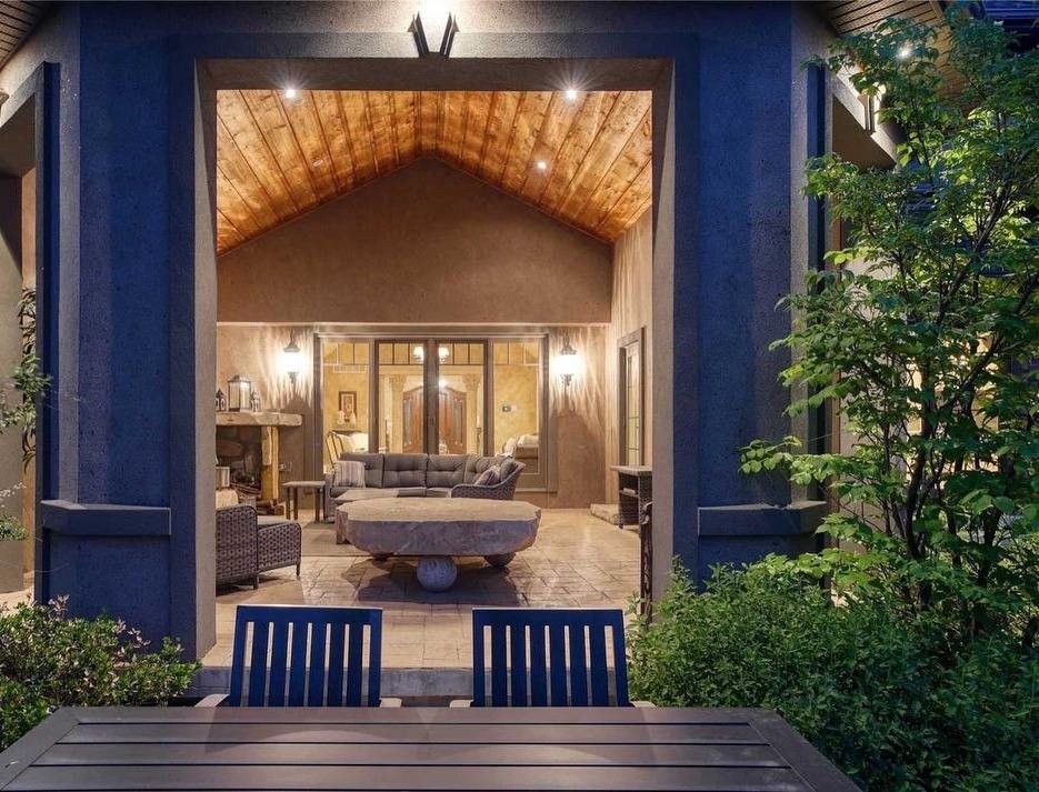 Covered rear patio addition with vaulted wood ceiling and open view to the yard