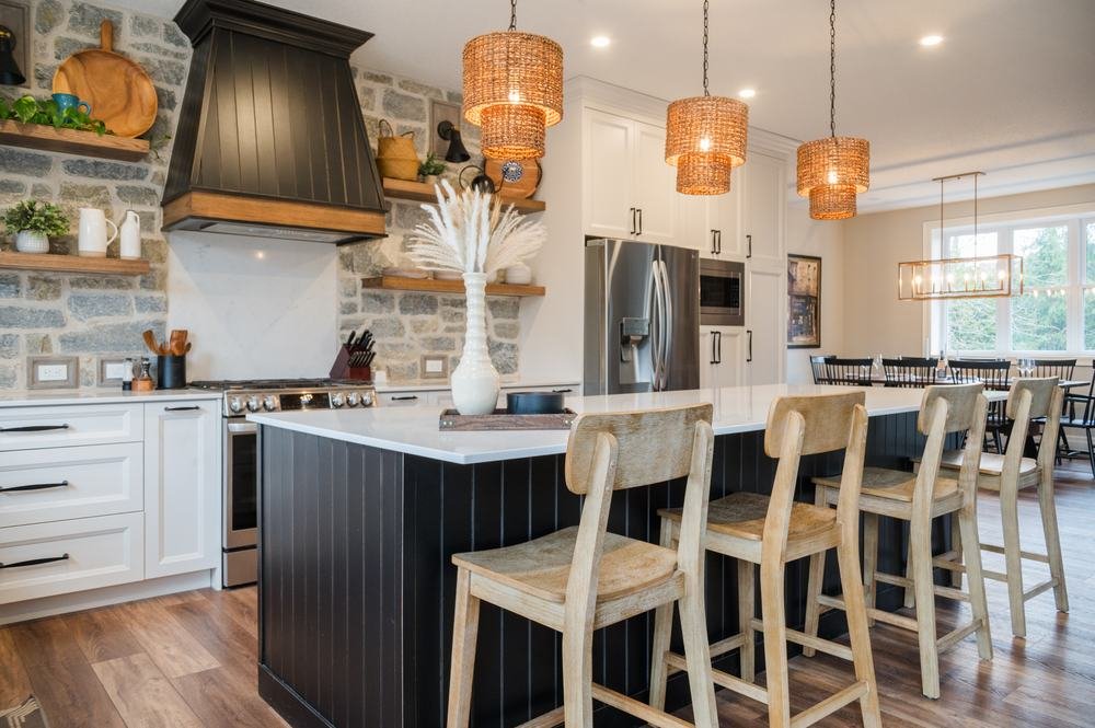 Custom kitchen with an island, stone counters and full-height cabinetry