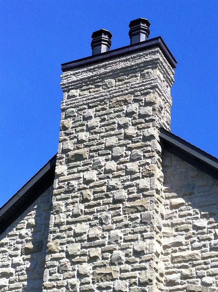 Rebuilt stone chimney, new cap and flue liners, finished above the roofline