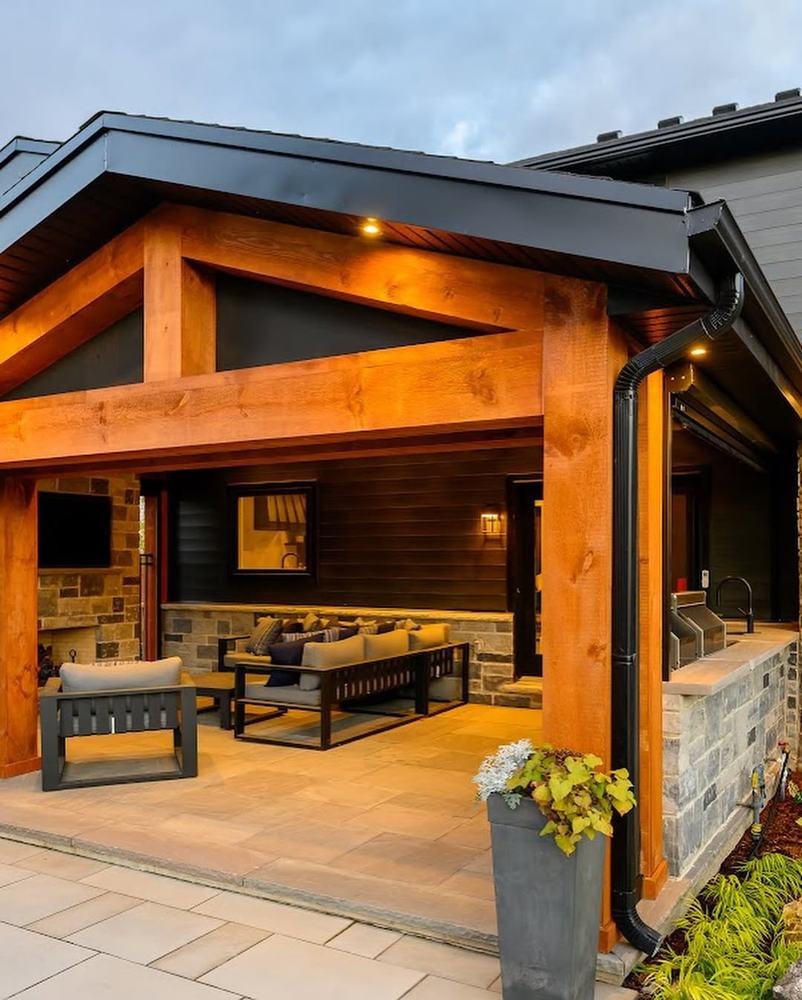Covered timber patio addition with stone piers and integrated outdoor seating